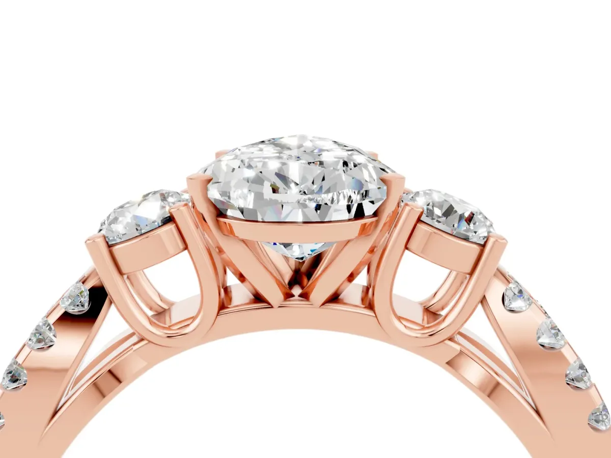 Pear Cut Moissanite Three-Stone Ring with Pavé Split Shank and Four-Prong Setting Rose gold