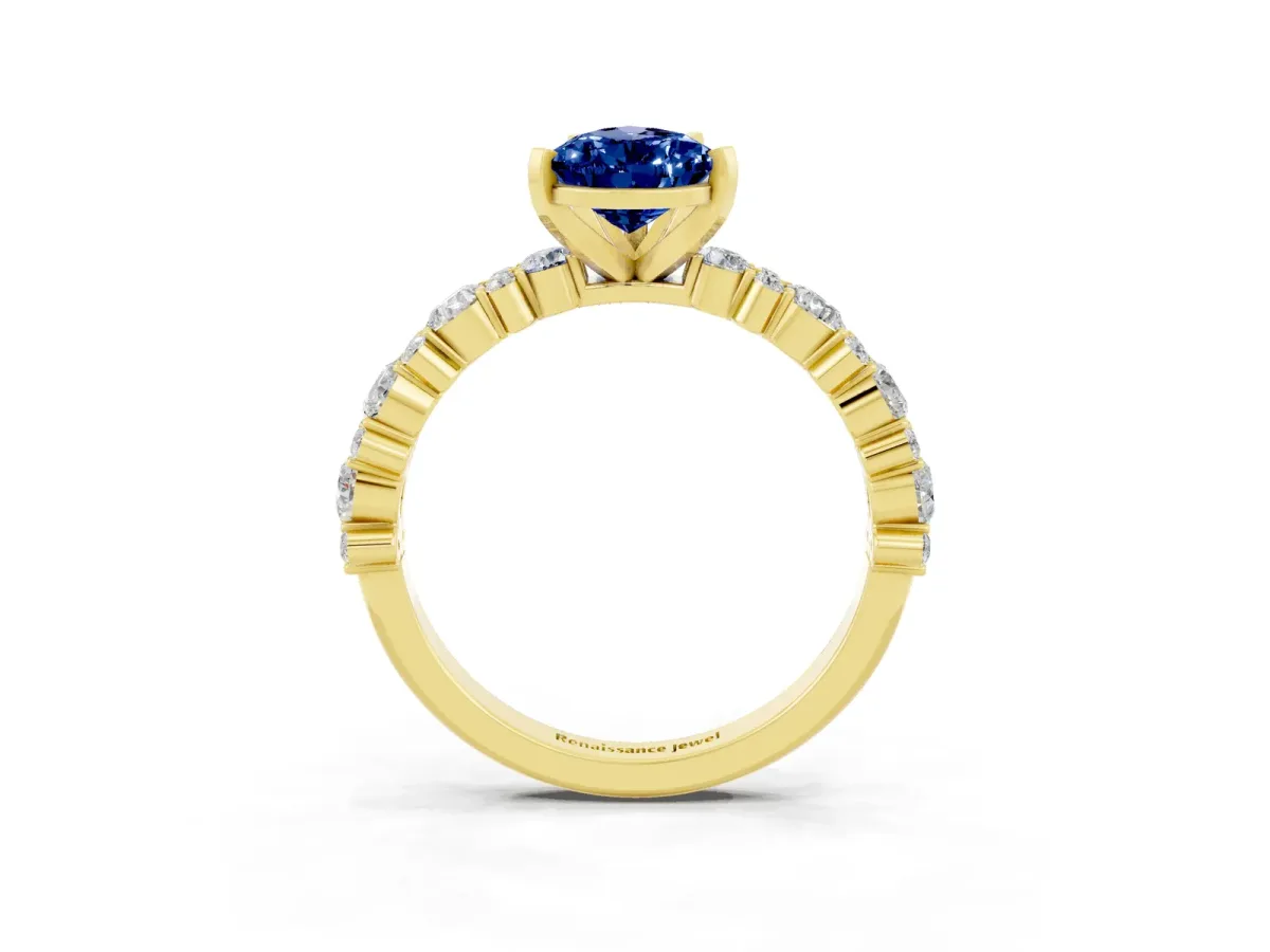 Pear Cut Blue Sapphire Side Stone Solitaire Ring with Round and Four-Prong Setting Yellow gold