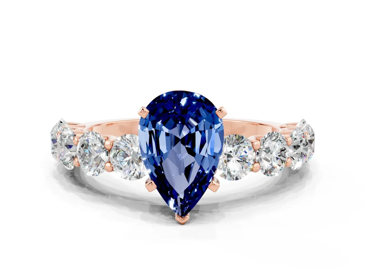 Pear Cut Blue Sapphire Prong Setting with Side Stones on a Pave Band Rose gold