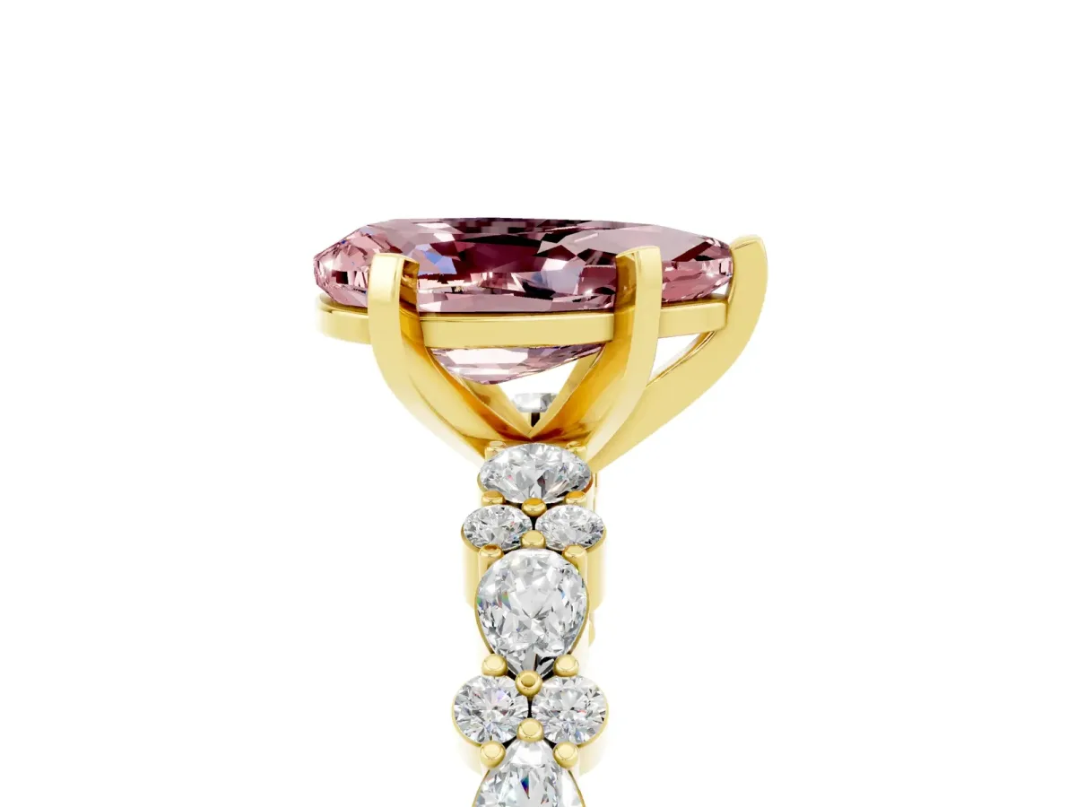 Pear Cut Morganite Side Stone Solitaire Ring with Round and Four-Prong Setting Yellow gold