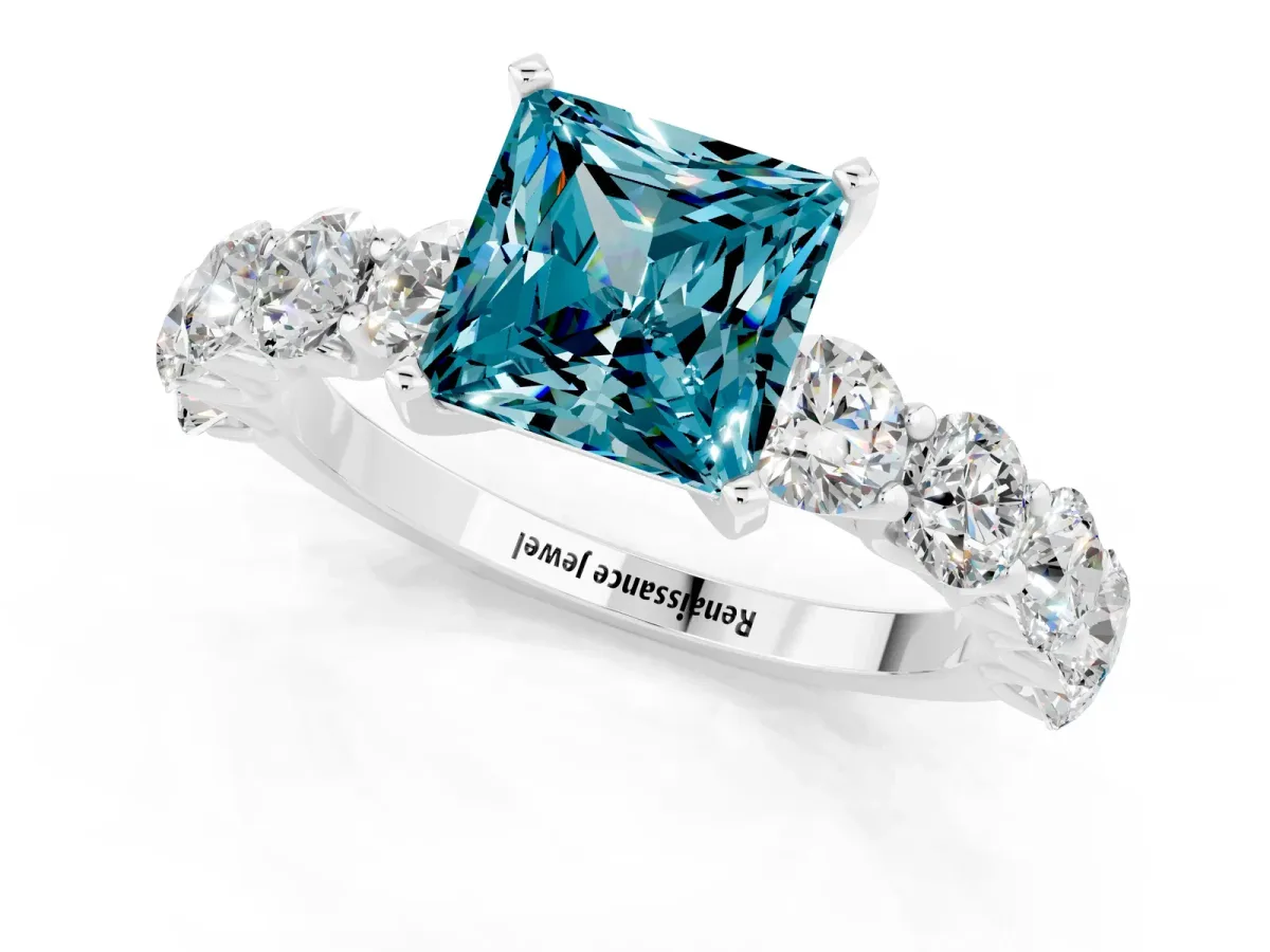 Princess Cut Blue Topaz Prong Setting with Side Stones on a Pave Band Silver