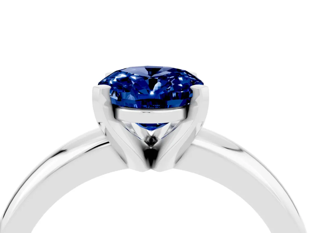 Oval Cut Blue Sapphire Solitaire Engagement Ring with Round Band and Four-Prong Setting Silver