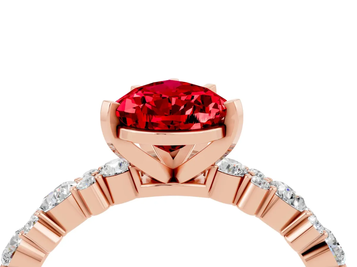 Pear Cut Ruby Side Stone Solitaire Ring with Round and Four-Prong Setting Rose gold
