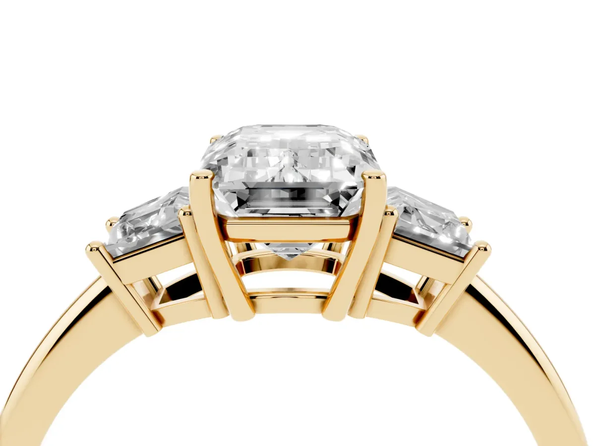 Emerald Cut Diamond Three-Stone Ring with Trapezoid Side Stones and Prong Setting Yellow gold