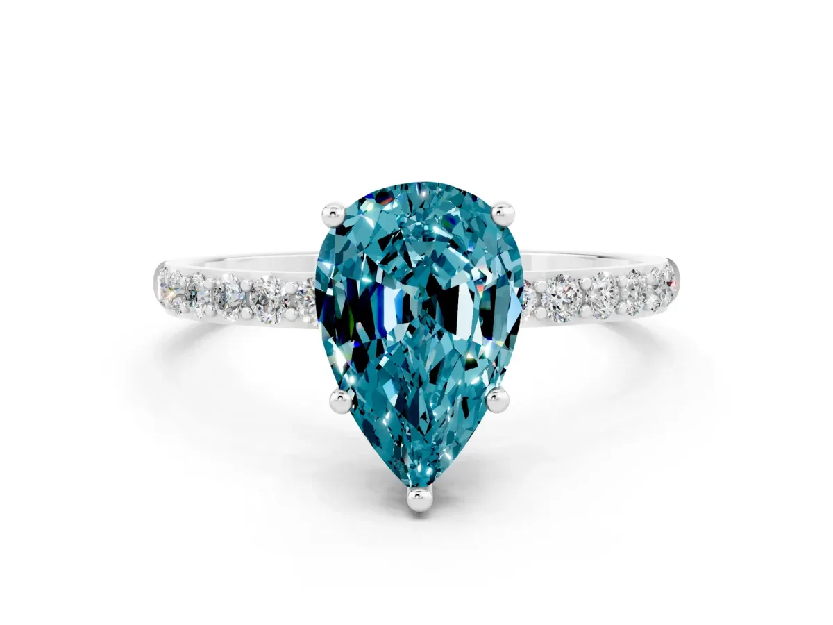 Pear Cut Blue Topaz Solitaire Ring with Round Pavé Band and Prong Setting Silver
