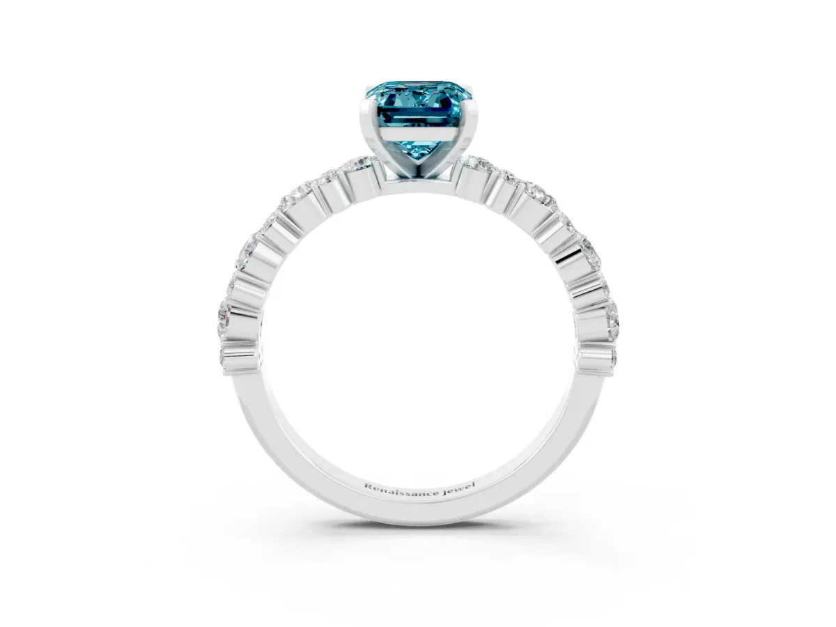 Emerald Cut Blue Topaz Side Stone Solitaire Ring with Round and Four-Prong Setting White gold