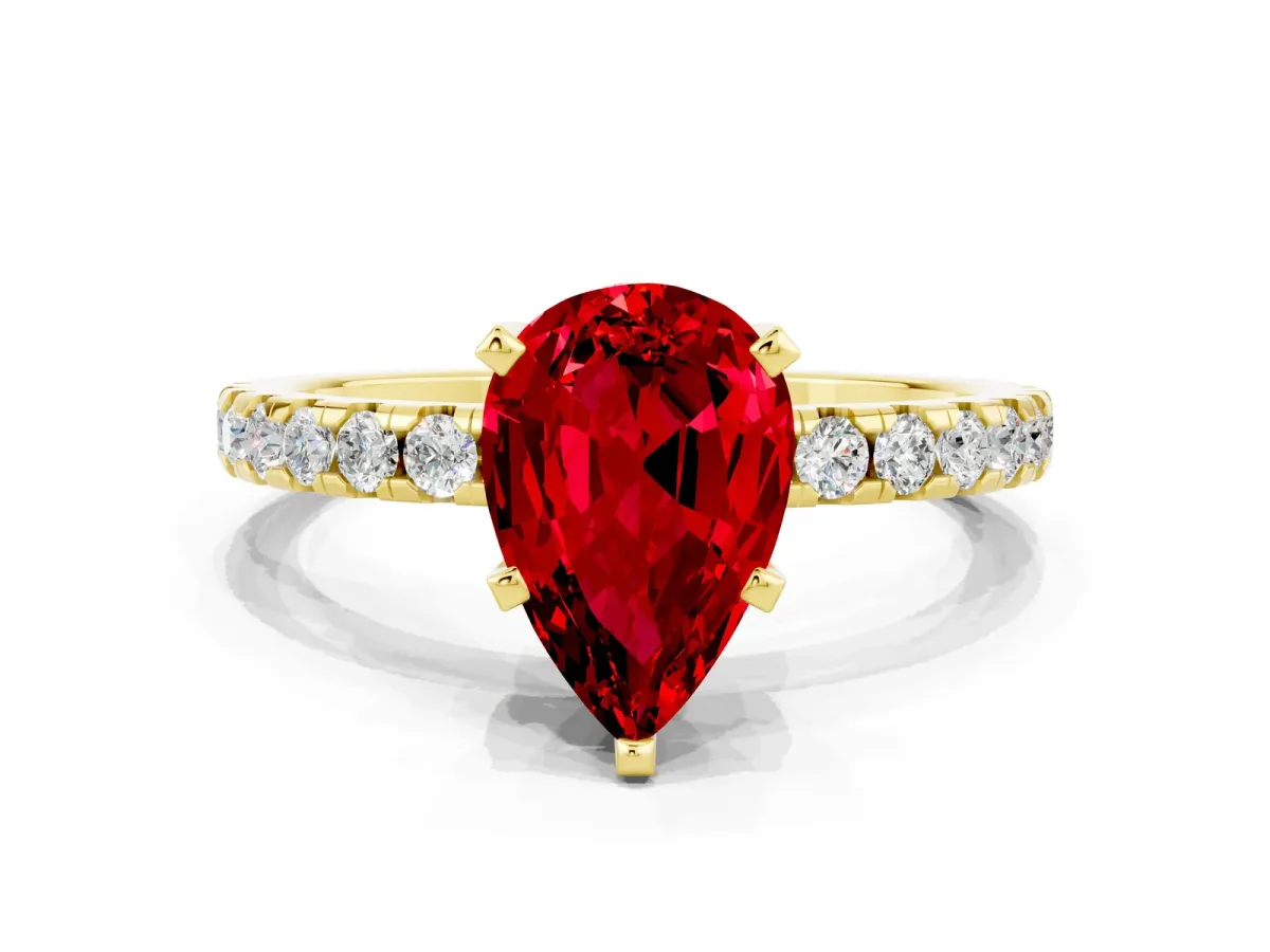 Pear Cut Ruby Solitaire Ring with Round Pavé Band and Four-Prong Setting Yellow gold