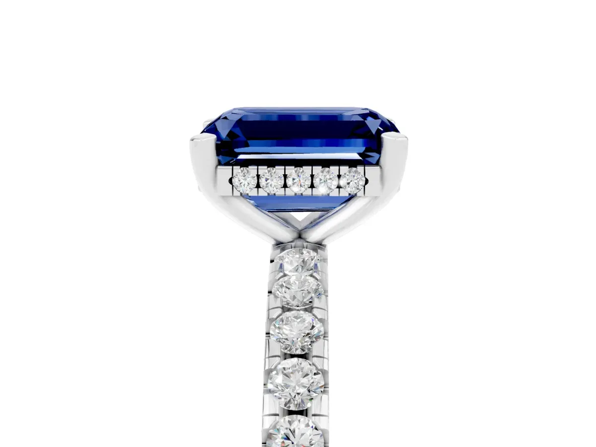 Emerald Cut Blue Sapphire Solitaire Ring with Round Pavé Band and Four-Prong Setting Silver