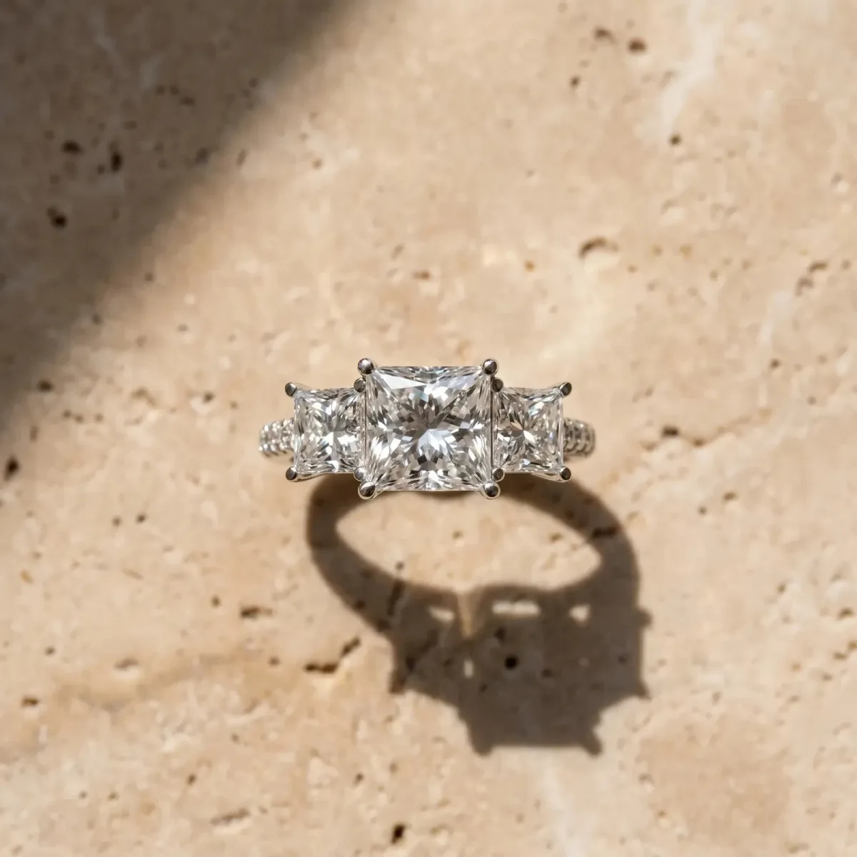 Three-Stone Princess Cut Diamond Ring with Round Pavé Band and Prong Setting Platinum