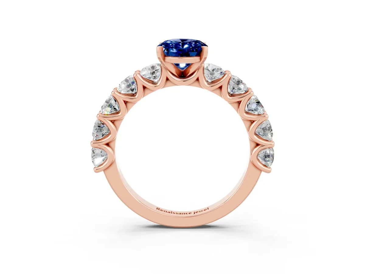 Oval Cut Blue Sapphire Prong Setting with Side Stones on a Pave Band Rose gold