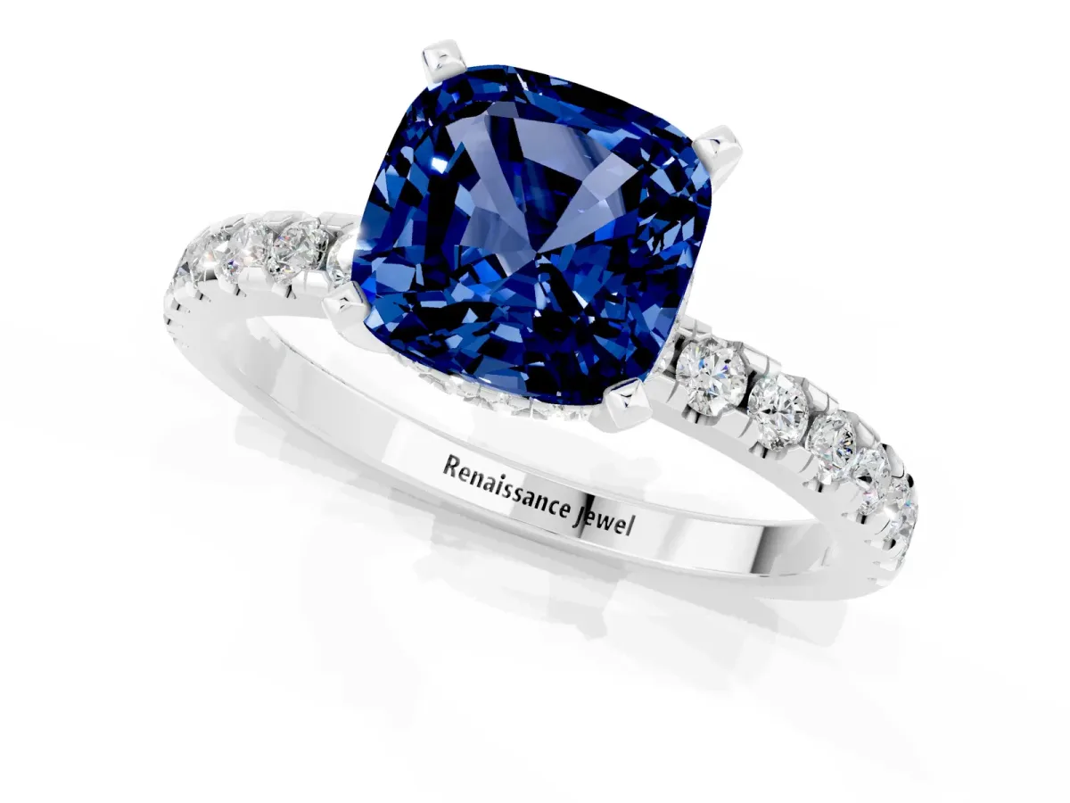 Cushion Cut Blue Sapphire Solitaire Ring with Round Pavé Band and Four-Prong Setting Silver