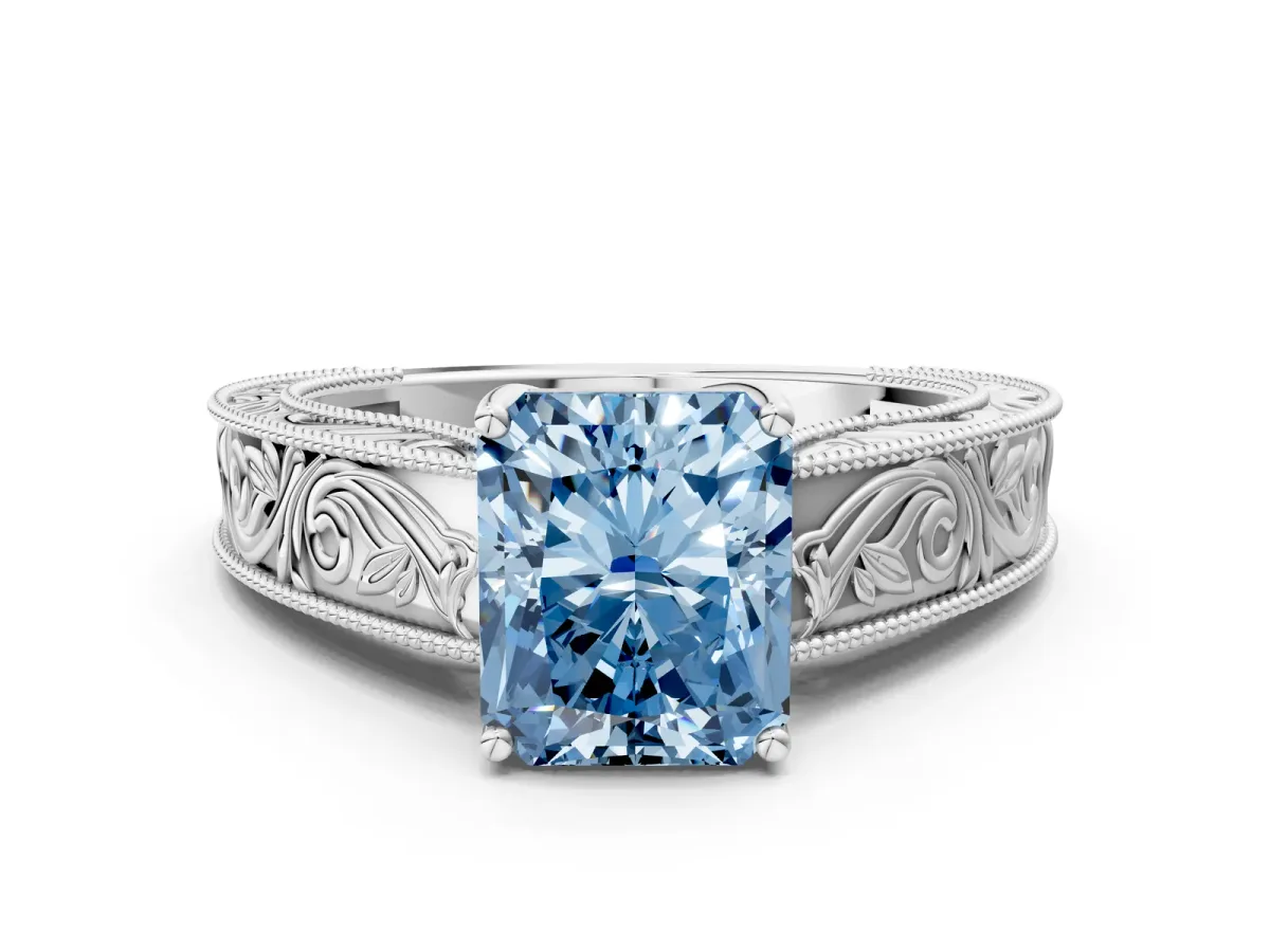 Fancy Blue Radiant Cut Diamond Solitaire Ring with Engraved Band and Four-Prong Setting Platinum