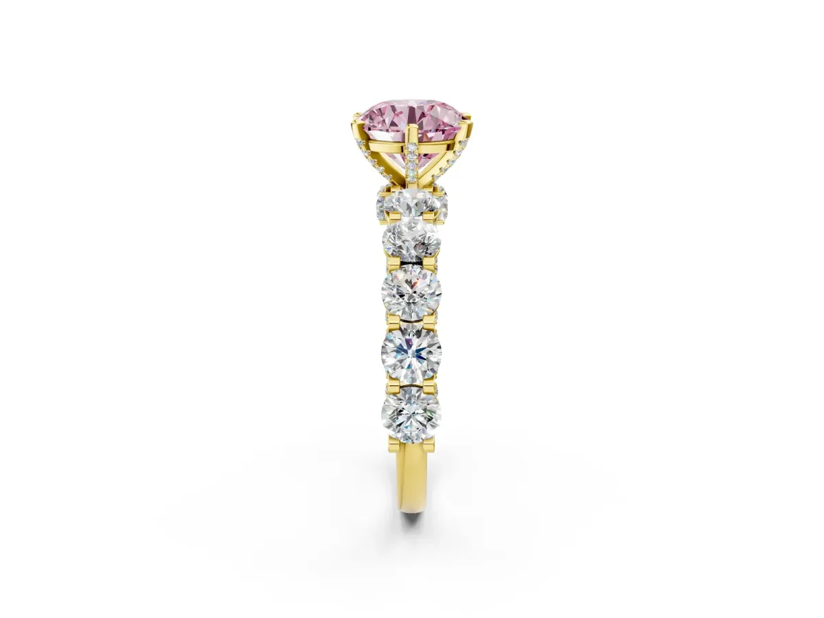 Fancy Pink Round Cut Diamond Side Stone Engagement Ring with Four-Prong Setting Yellow gold