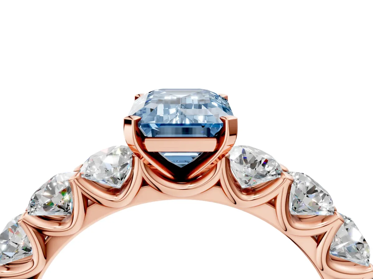Fancy Blue Emerald Cut Diamond Prong Setting with Side Stones on a Pave Band Rose gold