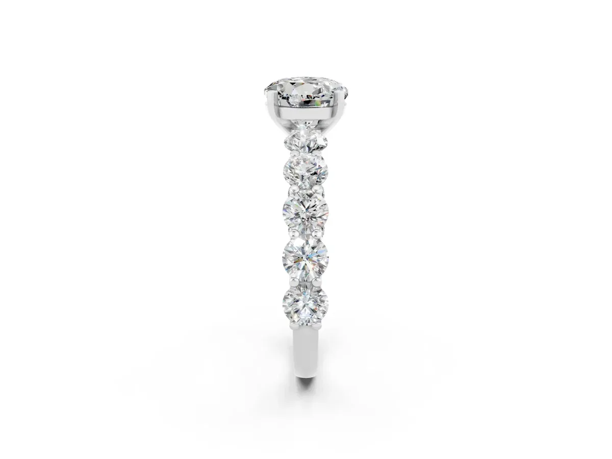 Round Cut Moissanite Prong Setting with Side Stones on a Pave Band Silver