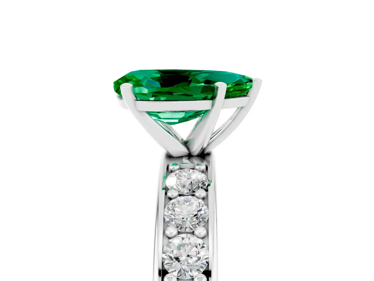 Pear Cut Emerald Engagement Ring with Channel Set Round Band and Prong Setting White gold