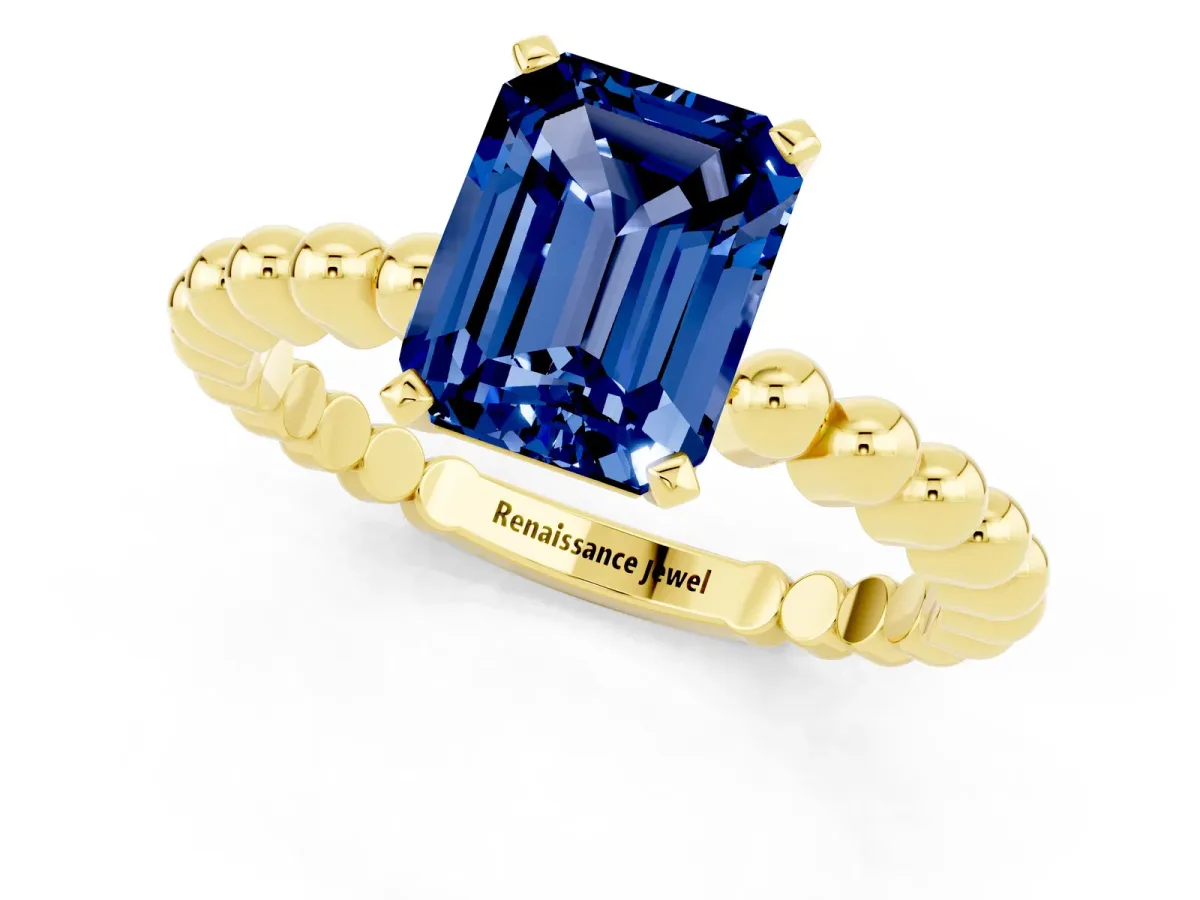 Emerald Cut Blue Sapphire Solitaire Ring with Beaded Band and Prong Setting Yellow gold