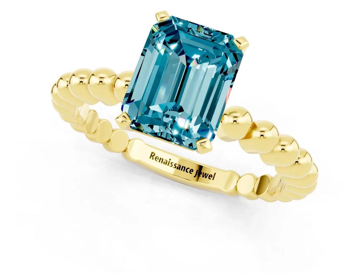 Emerald Cut Blue Topaz Solitaire Ring with Beaded Band and Prong Setting Yellow gold
