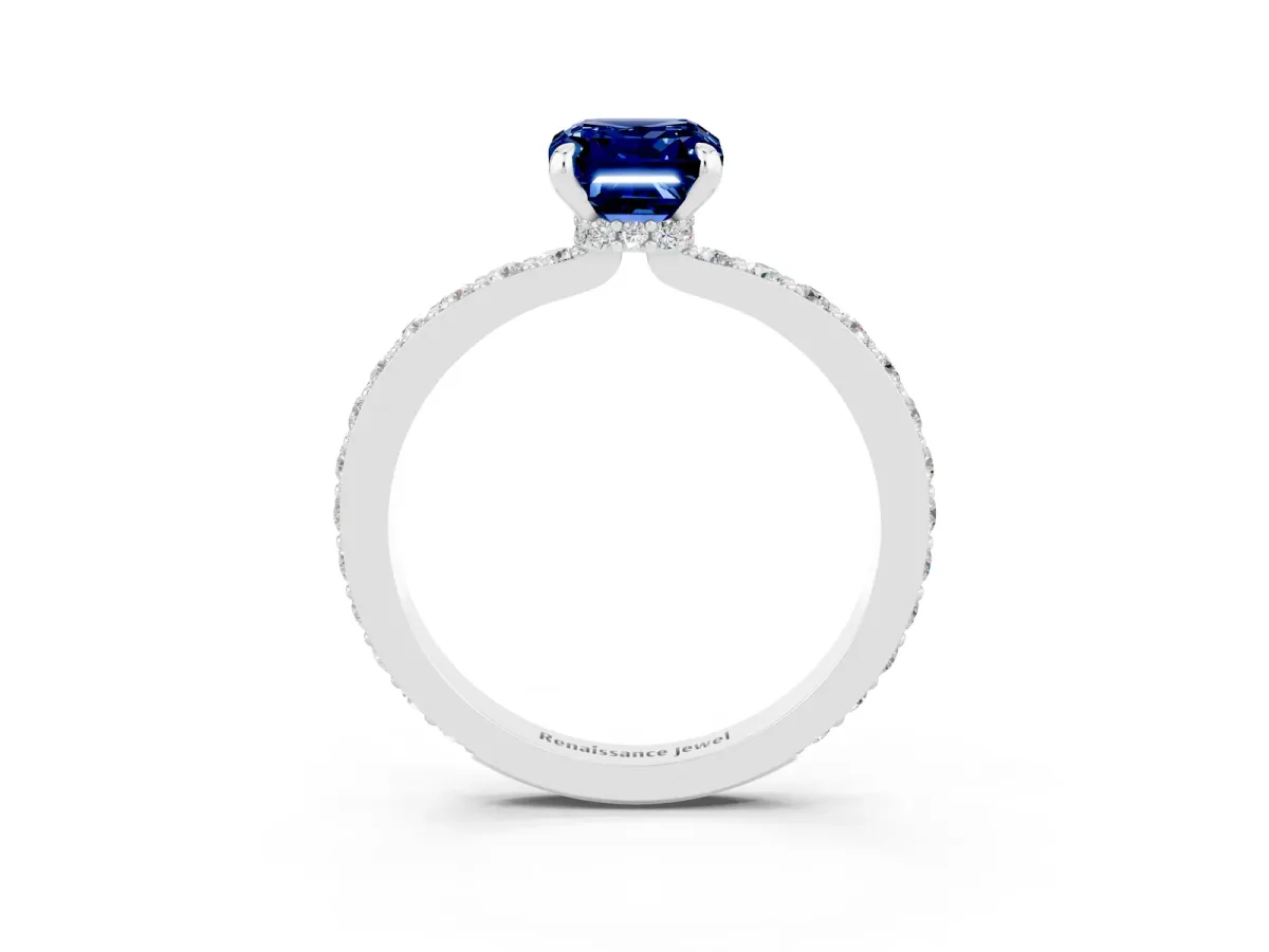 Emerald Cut Blue Sapphire Solitaire Engagement Ring with Pavé Band and Four-Prong Setting Silver