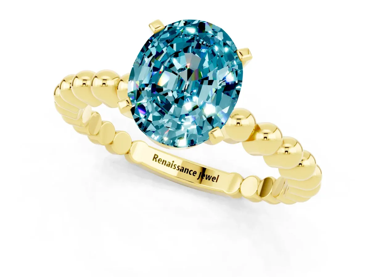 Oval Cut Blue Topaz Solitaire Ring with Beaded Band and Prong Setting Yellow gold