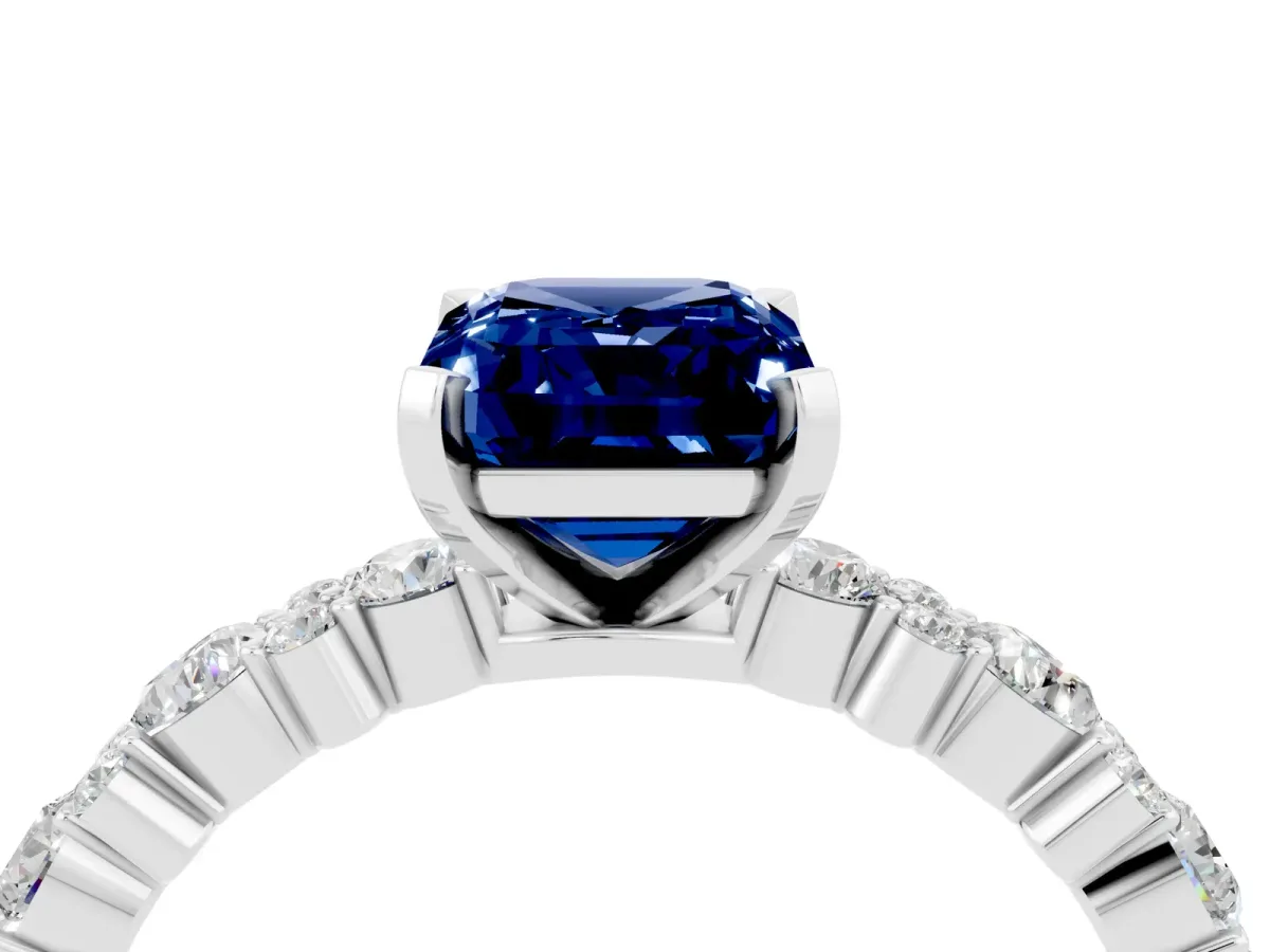 Emerald Cut Blue Sapphire Side Stone Solitaire Ring with Round and Four-Prong Setting White gold