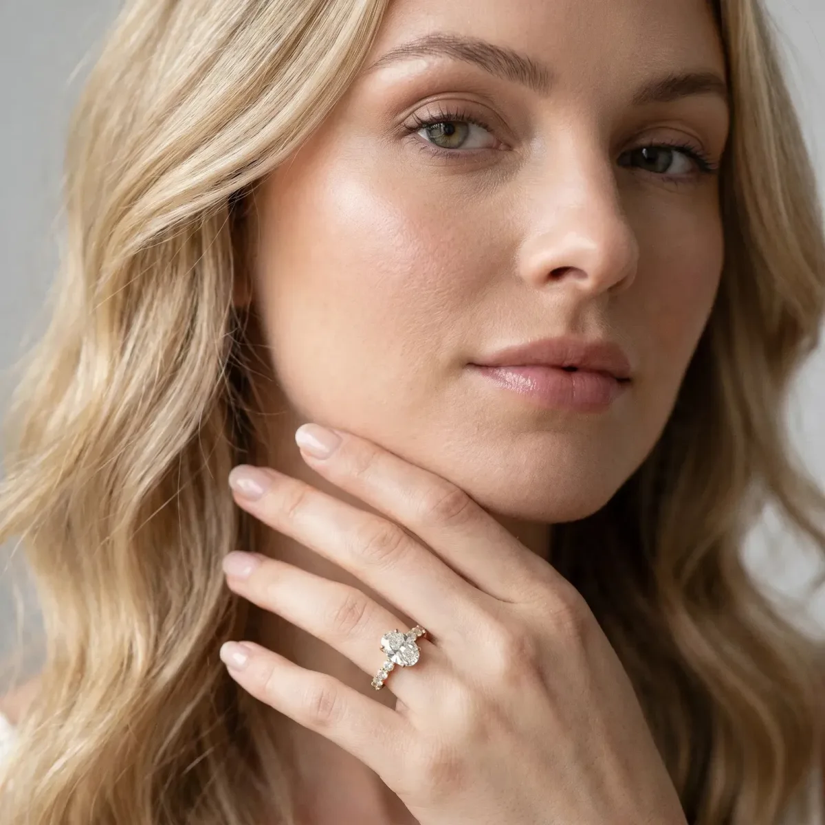 Oval Cut Solitaire Diamond Ring with Pave Band and Four-Prong Setting Yellow gold