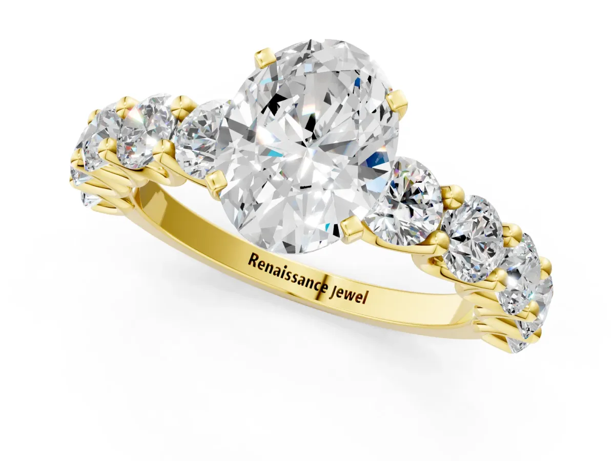 Oval Cut Diamond Prong Setting with Side Stones on a Pave Band Yellow gold
