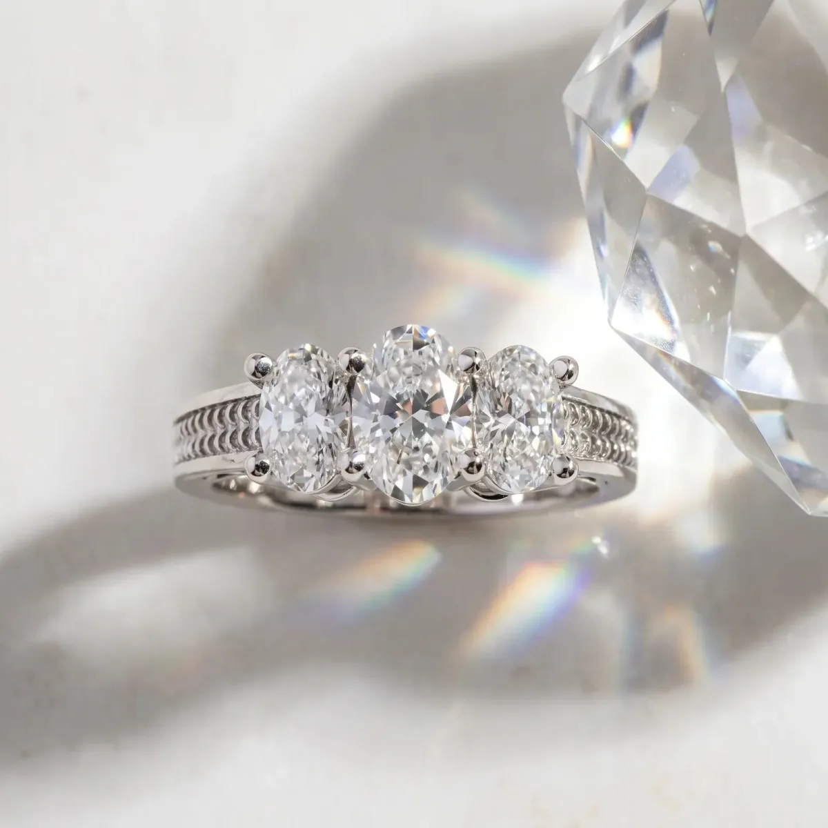 Asscher Cut Diamond Three-Stone Ring with Prong Setting and Textured Band Platinum