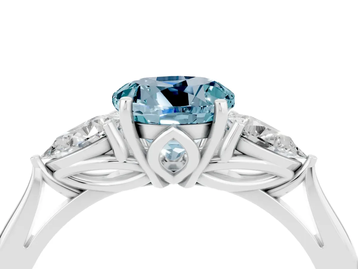 Three-Stone Round Cut Aquamarine Ring with Pear Side Stones in Four-Prong Setting Platinum