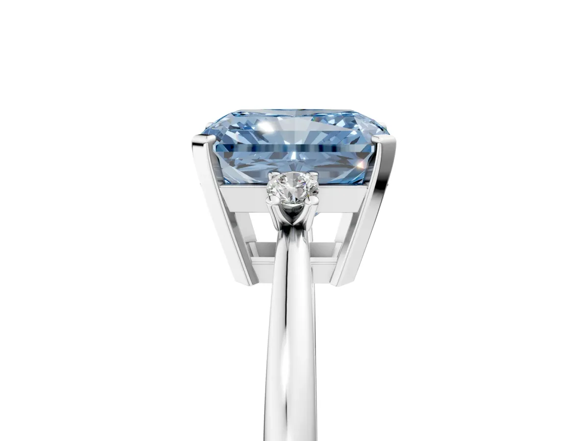 Fancy Blue Radiant Cut Cut Three-Stone Solitaire Ring with Round Accent Diamonds and Four-Prong Setting Platinum