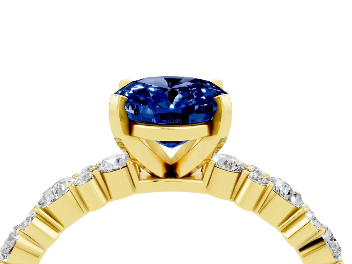 Oval Cut Blue Sapphire Side Stone Solitaire Ring with Round and Four-Prong Setting Yellow gold