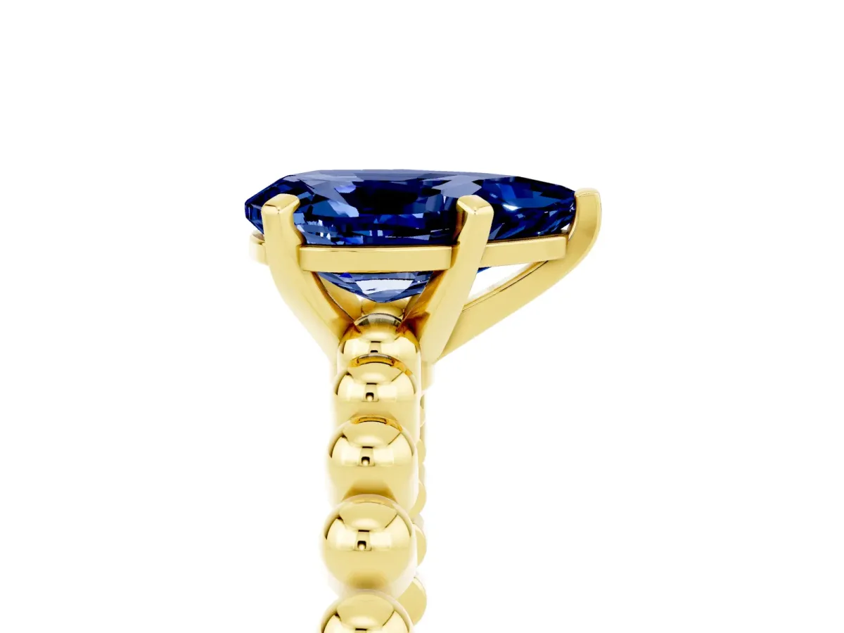 Pear Cut Blue Sapphire Solitaire Ring with Beaded Band and Prong Setting Yellow gold