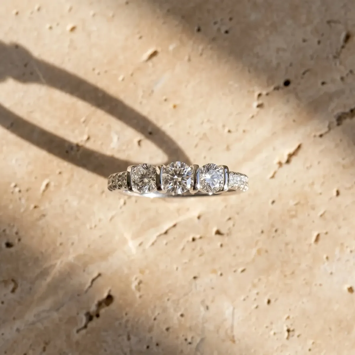 Round Cut Brilliant Trilogy Channel Set Diamond Ring with Bar Prongs Platinum