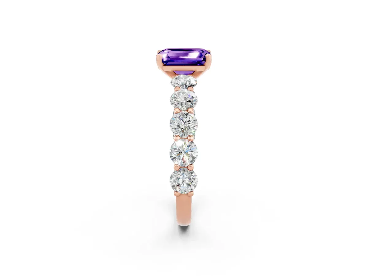 Emerald Cut Tanzanite Prong Setting with Side Stones on a Pave Band Rose gold