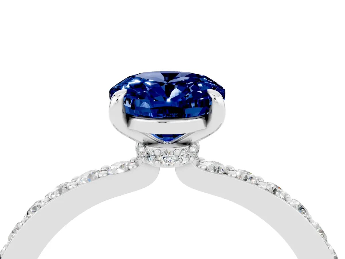 Oval Cut Blue Sapphire Solitaire Engagement Ring with Pavé Band and Four-Prong Setting Silver