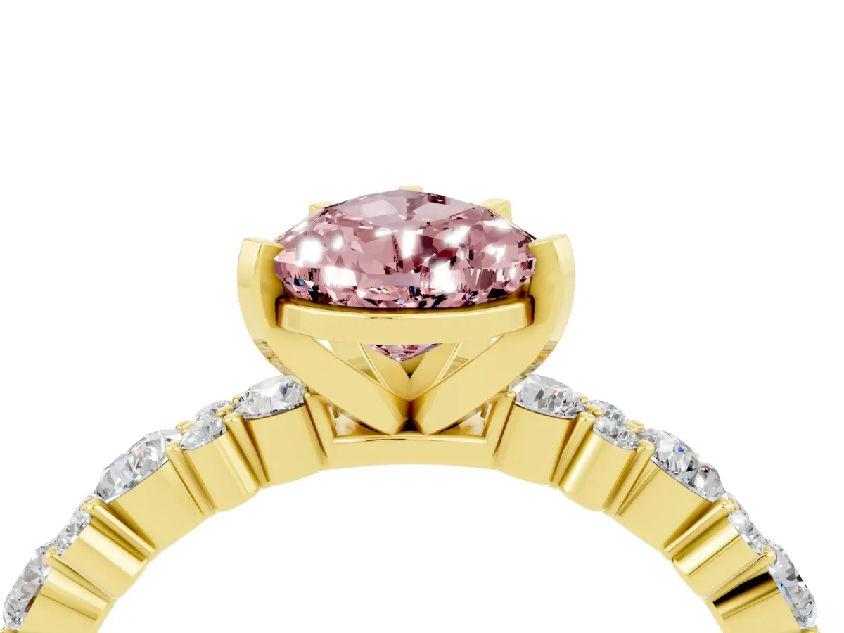 Pear Cut Morganite Side Stone Solitaire Ring with Round and Four-Prong Setting Yellow gold