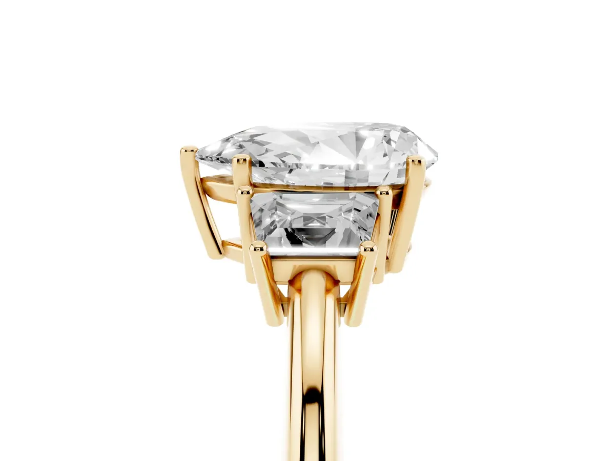 Pear Cut Diamond Three-Stone Ring with Trapezoid Side Stones and Prong Setting Yellow gold