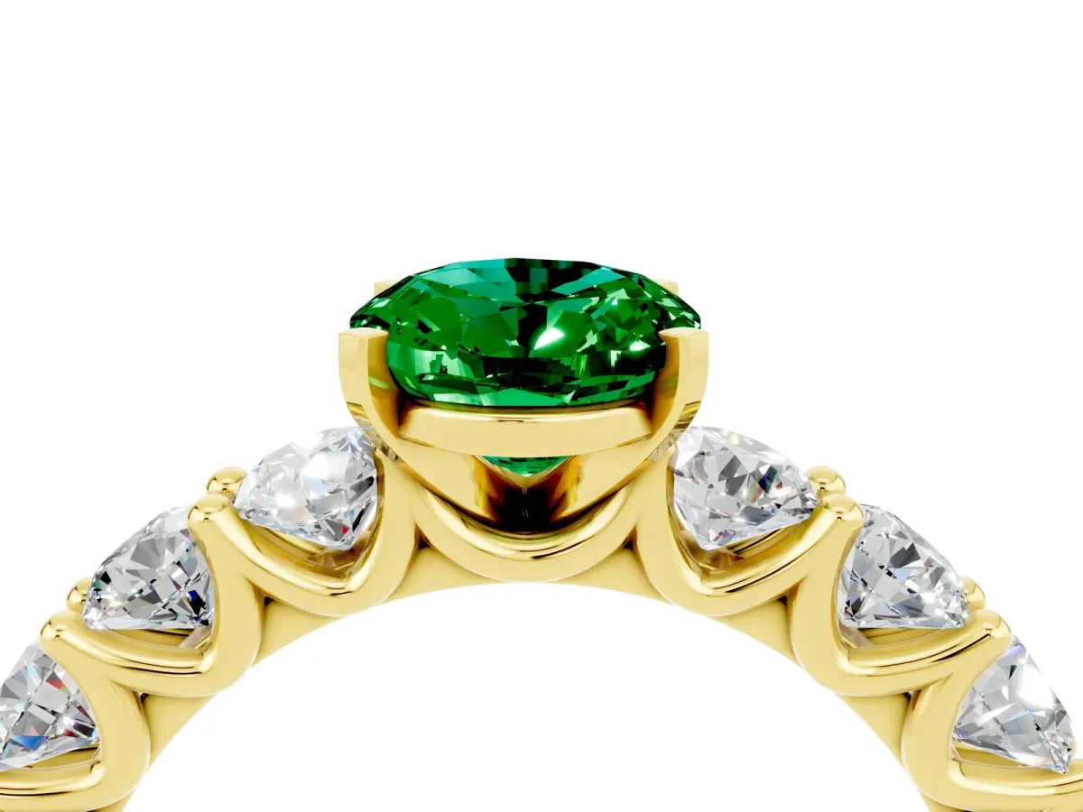 Oval Cut Emerald Prong Setting with Side Stones on a Pave Band Yellow gold