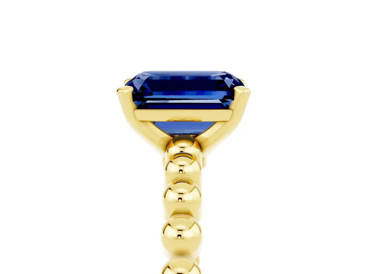 Emerald Cut Blue Sapphire Solitaire Ring with Beaded Band and Prong Setting Yellow gold