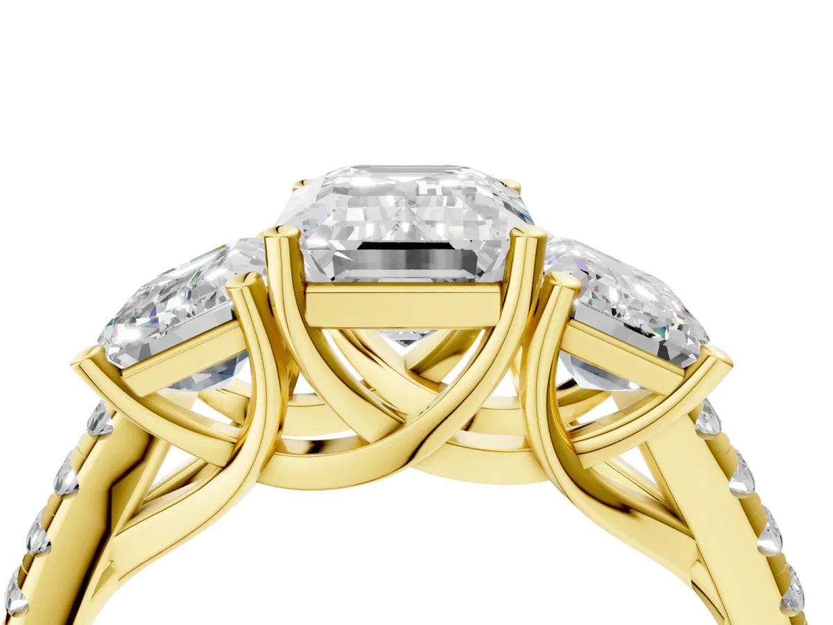 Three-Stone Emerald Cut Diamond Ring with Round Pavé Band and Prong Setting Yellow gold