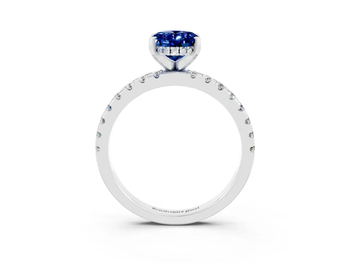 Oval Cut Blue Sapphire Solitaire Ring with Round Pavé Band and Four-Prong Setting Silver