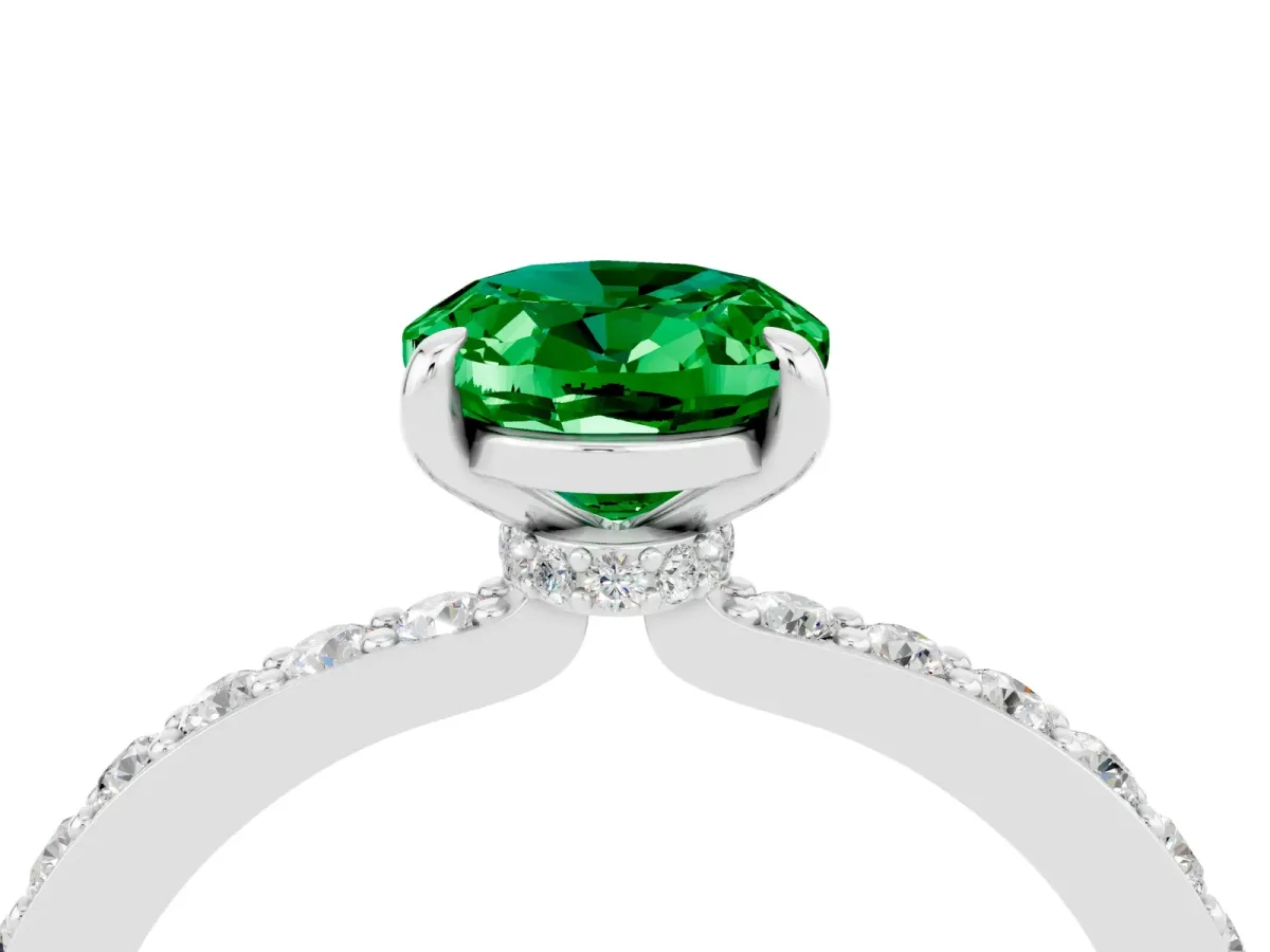 Oval Cut Emerald Solitaire Engagement Ring with Pavé Band and Four-Prong Setting Silver