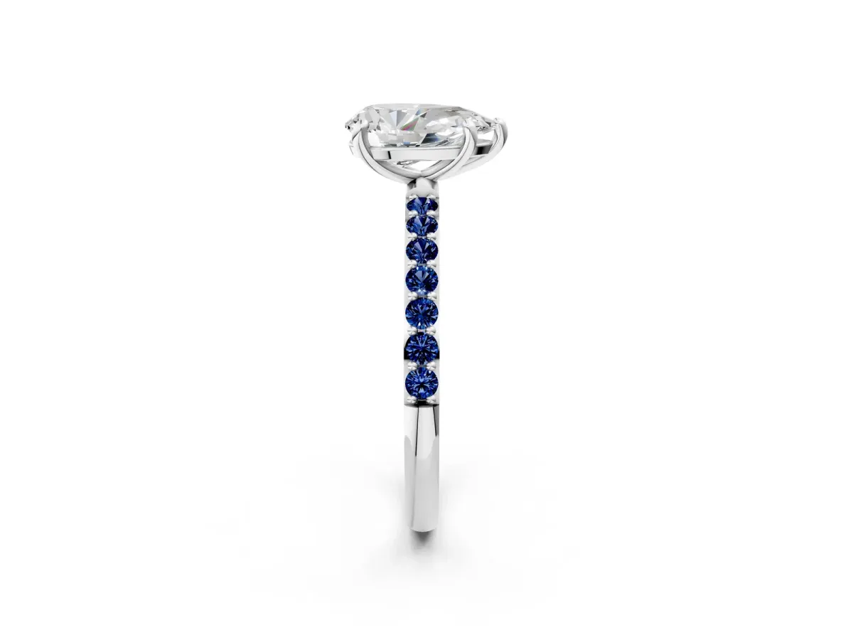 Pear Cut Diamond Solitaire Ring with Round Blue Sapphire Pavé Band and Prong Setting Silver