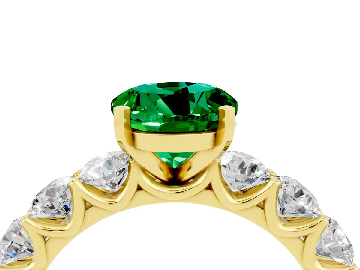 Round Cut Emerald Prong Setting with Side Stones on a Pave Band Yellow gold