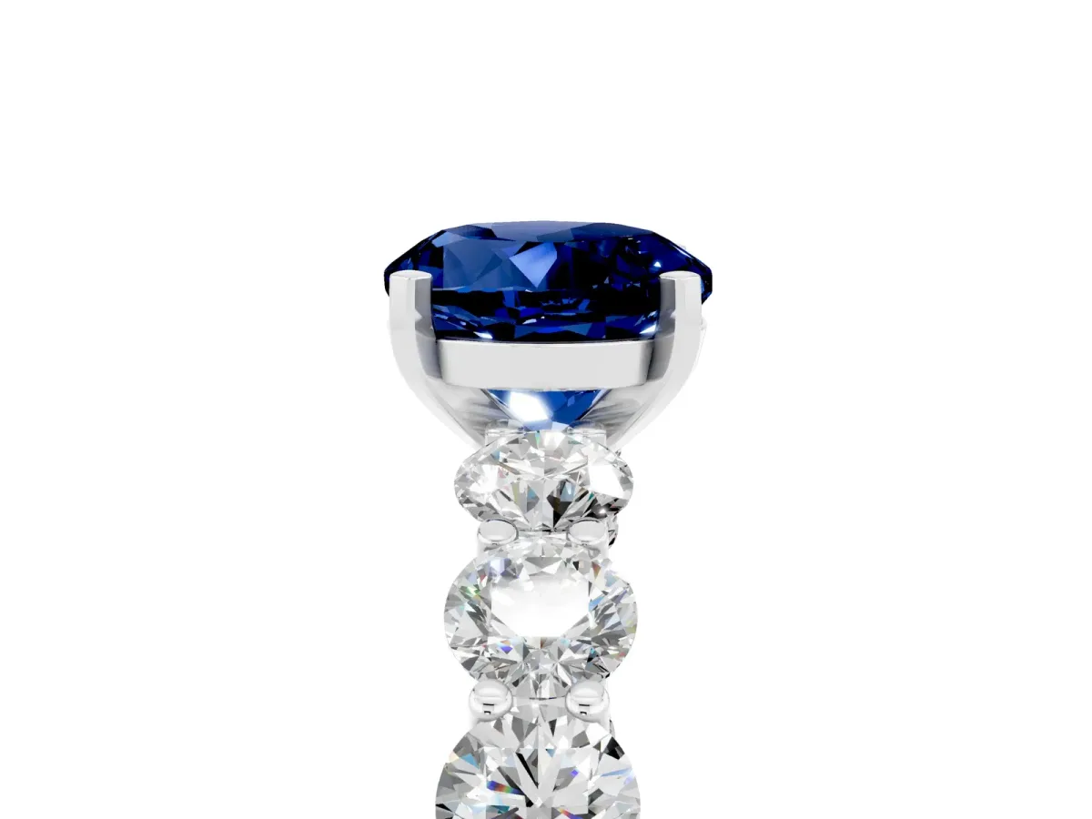 Round Cut Blue Sapphire Prong Setting with Side Stones on a Pave Band Platinum