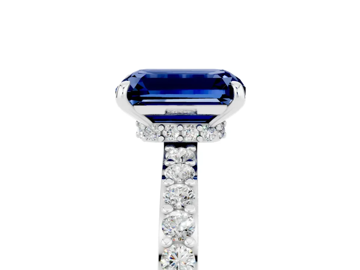 Emerald Cut Blue Sapphire Solitaire Engagement Ring with Pavé Band and Four-Prong Setting Silver