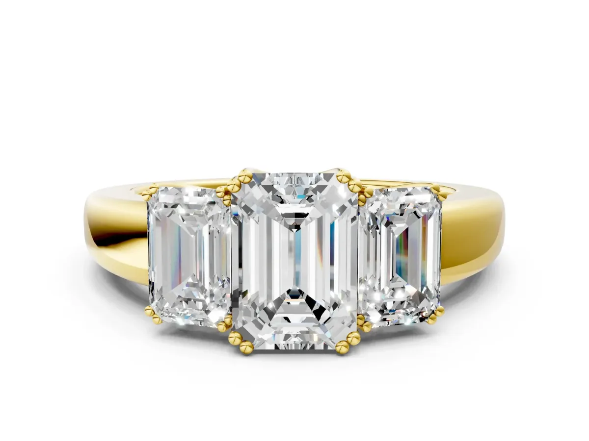 Three-Stone Emerald Cut Cut Diamond Ring with Channel Set Band and Four-Prong Setting Yellow gold