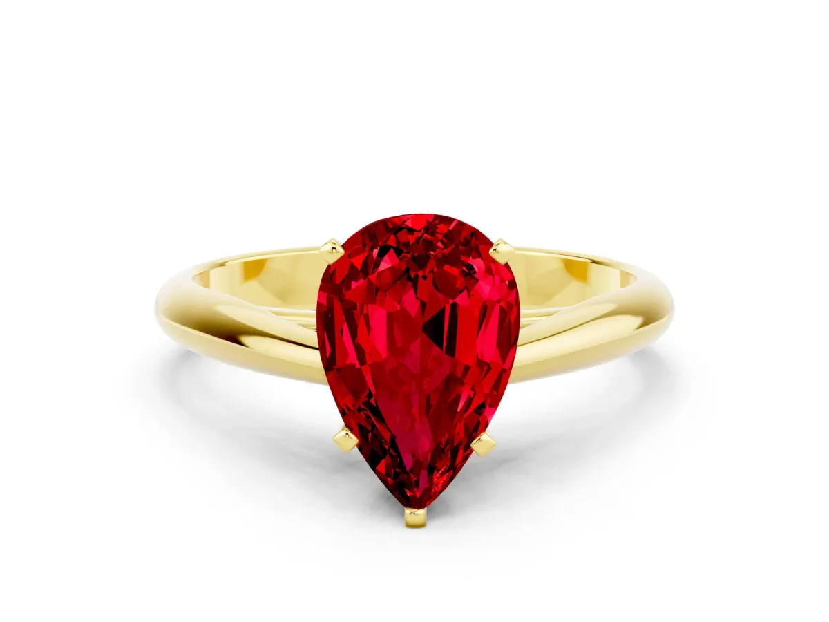 Pear Cut Ruby Solitaire Engagement Ring with Cathedral Setting and Four-Prong Mount Yellow gold