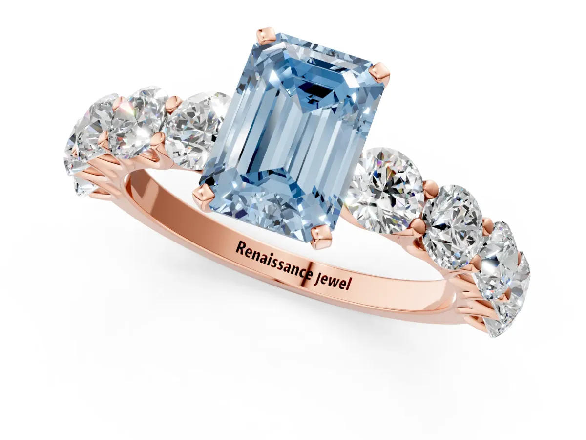 Fancy Blue Emerald Cut Diamond Prong Setting with Side Stones on a Pave Band Rose gold