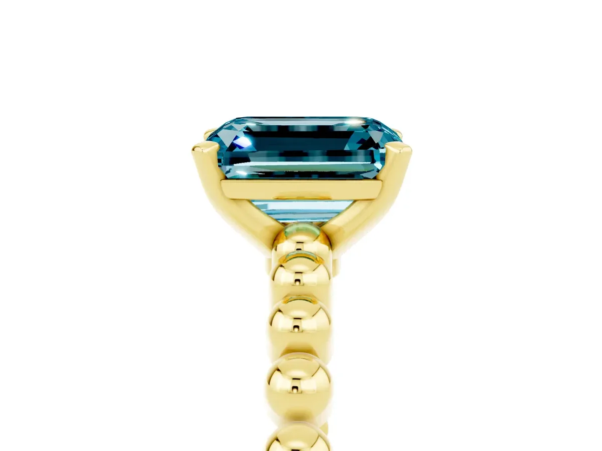 Emerald Cut Blue Topaz Solitaire Ring with Beaded Band and Prong Setting Yellow gold